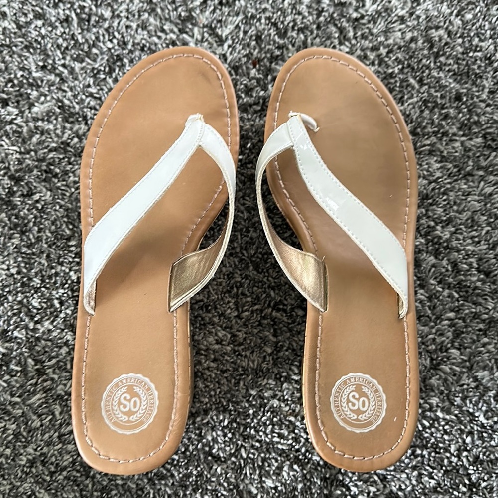 So white strap beige wedge heel.